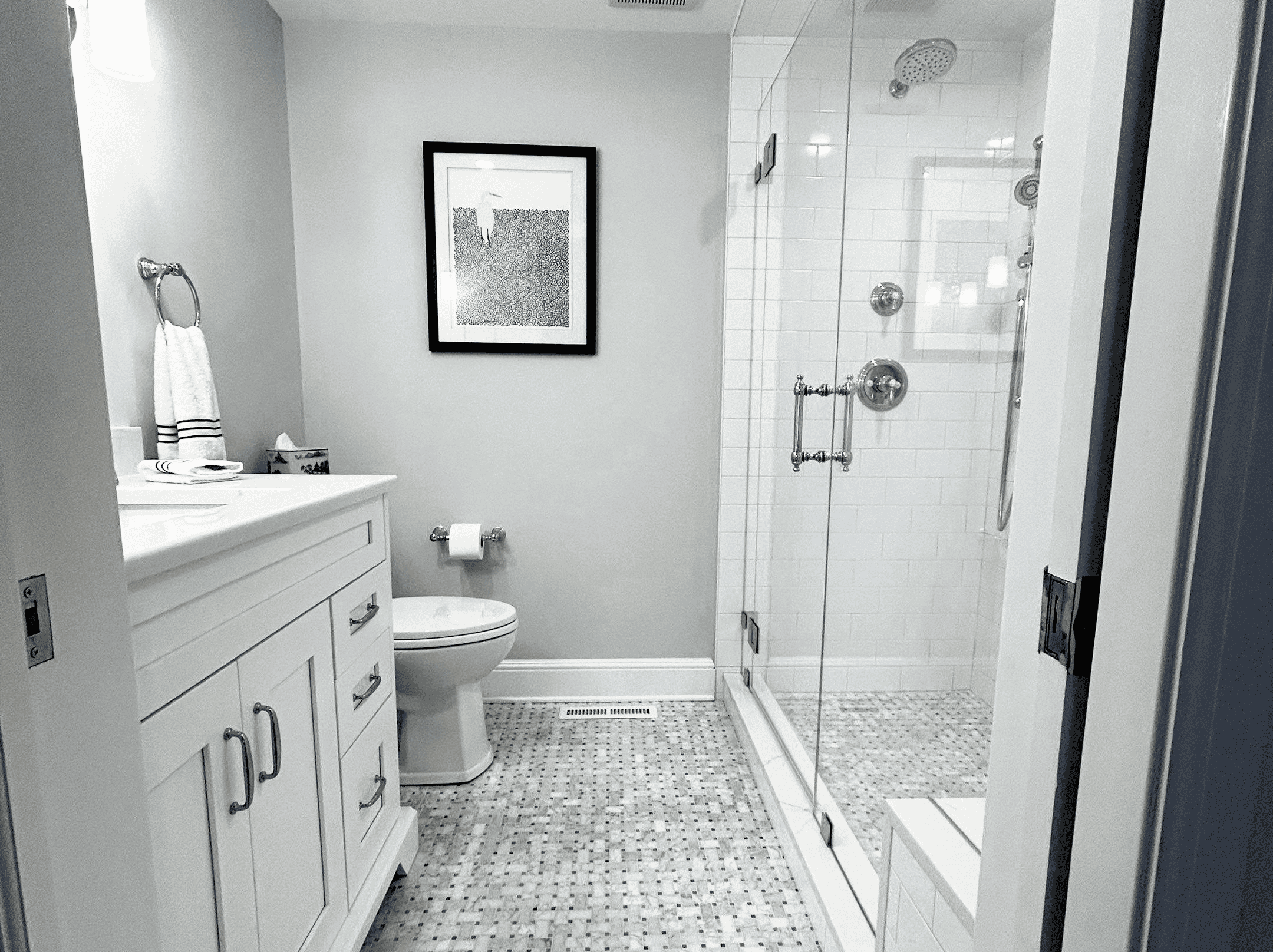 Bathroom Renovation Modern bathroom with glass shower enclosure and white fixtures.